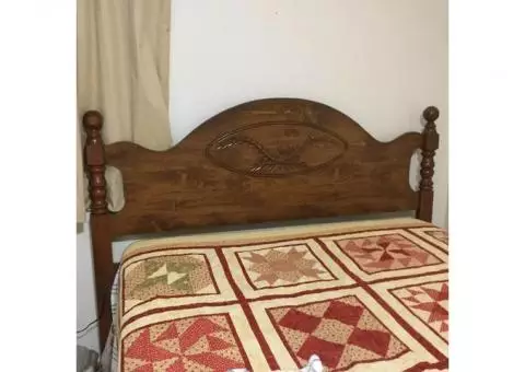 Double bed with mattress and wood headboard